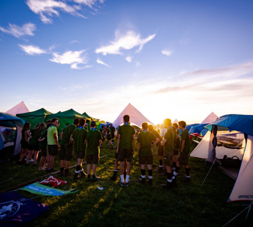 Tents and Jamboree participants are silhouetted in a sunset at a camp site on Sobieszewo Island, Gdansk, Poland August 6, 2018. ZHP/Weronika Malachowska